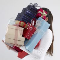 Woman carrying gift boxes.